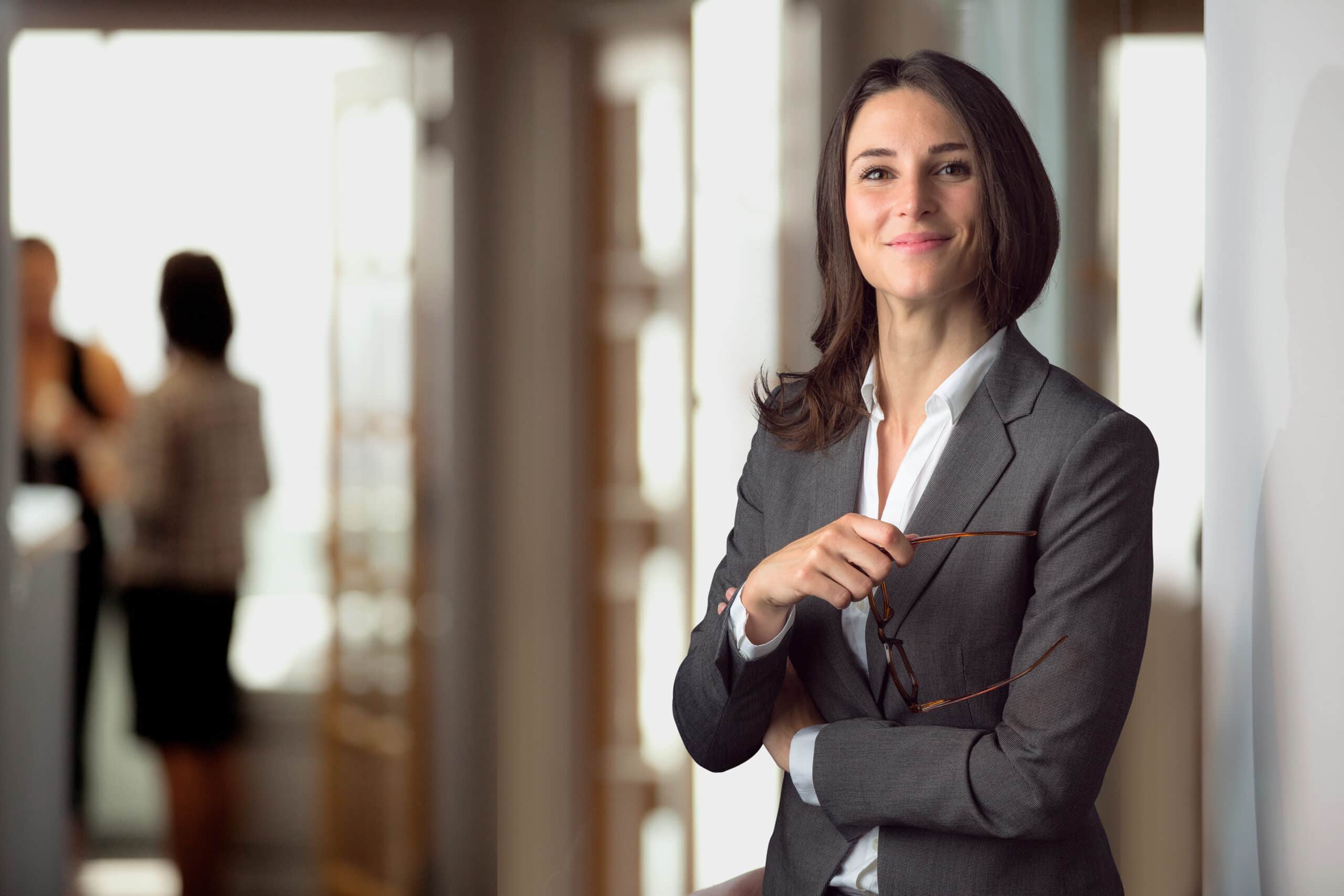 Candid portrait of a joyful cheerful happy employee staff member leader at the office workspace Candid portrait of a joyful cheerful happy employee staff member leader at the office workspace