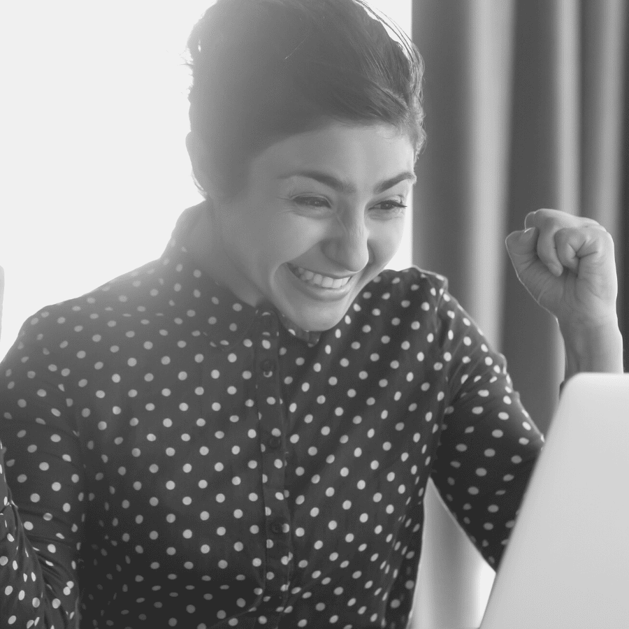 woman smiling in front of a laptop